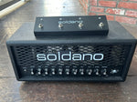 Soldano Astro 20 black guitar head with metal frill and eleven knob controls, with black footwitch on top of amplifier