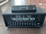 Soldano Astro 20 black guitar head with metal frill and eleven knob controls, with black footwitch on top of amplifier