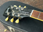 Close up, black Gibson headstock black with truss cover Traditional 