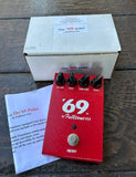 Red '69 Fulltone USA guitar pedal with packaging on a wooden surface
