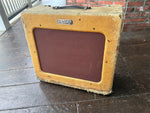 Tweed Amplifier with brown cloth front, Fender badge with leather handle 
