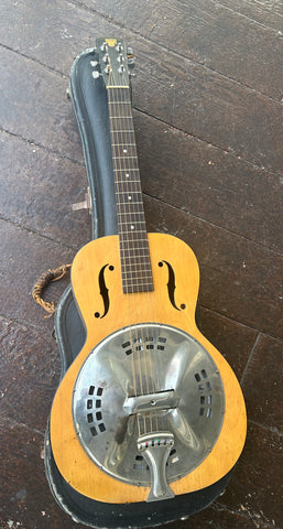 top view Dobro, metal cover, resonator, natural wood body with f holes, with rosewood fretboard, dobro logo headstock