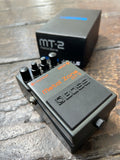 Black Boss Metal Zone MT-2 guitar effects pedal on a wooden surface