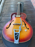 close up bigsby on red sunburst guitar, f sound holes, tan pick up by neck 