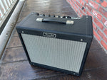Front, fender blues junior amplifier black covering, grey front, black handle, fender badge, 
