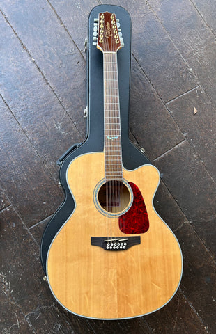 Top View: Takaminie natural top with brown pick guard, rosewood fretboard, headstock brown with gold tuners