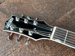 close up headstock, black with Gretsh script, six plus six machine tuners, black truss cover