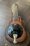 Top view National Duolian brown sunburst with metal cover, two sound holes upper bout, rosewood fretboard