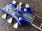 close up headstock, blue with off white machine tuners, with truss cover with McCarty 594 imprinted on black truss cover
