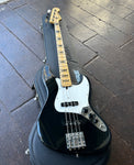 Fender Jazz Bass black finish, white pick guard, two black pick ups, maple neck, black block inlays, maple fender headstock with four in line tuners