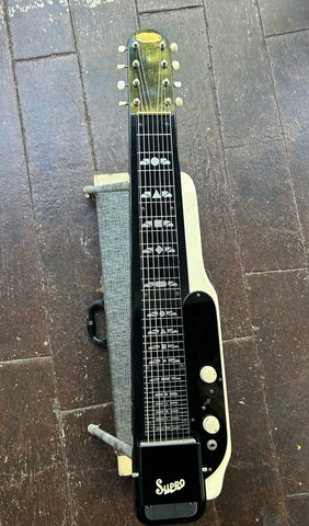 Supro Console 8 Lap Steel guitar black with white trim and black headstock on stand