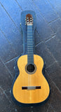 1966 Manuel Velazquez classical guitar with spruce top, ebony fretboard, rosewood bridge and headstock on wooden surface