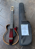 Yamaha SLG200NW Silent Nylon-String Wide-Neck guitar with wood frame, ebony fretboard and brown headstock.
Displayed with black gig bag and manual  