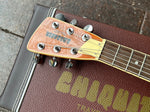 Close up: headstock Chiquita guitar with three plus three Grover tuners, tan truss rot cover