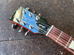 Closeup of headstock for 2022 Gibson Les Paul Studio Tangerine Burst