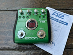 Zoom A2 Acoustic Effects Pedal, green with four control knobs, two button foot switch, digital readout center of pedal