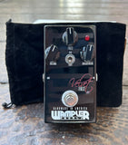Closeup of Wampler Velvet Fuzz propped up against included box and velvet pouch