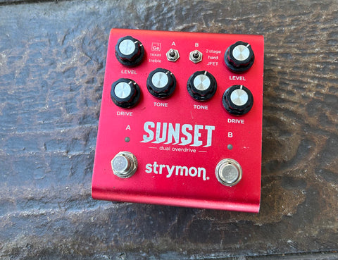 Red metal Strymon Sunset Dual Overdrive with six control knobs, two button metal footswitches 