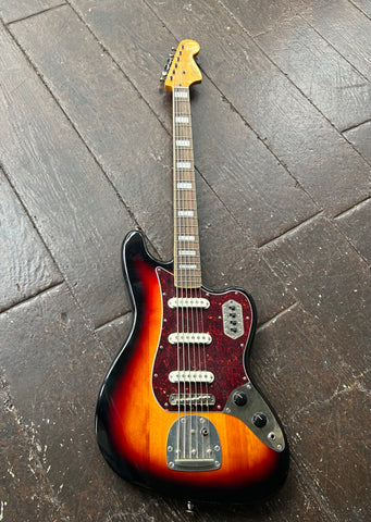 Squier Bass VI sunburst with rosewood fretboard and maple headstock, tortoise pickguard and three pickups