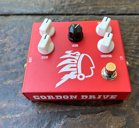 Gordon drive red guitar pedal, four control knobs, single button footswitch