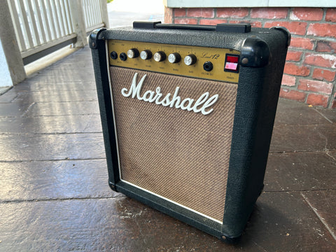 Marshall Lead twelve amplifier with black tolex, tan grill cloth and cold control panel, with five knobs
