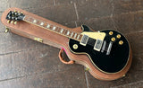 top view black gibson les paul, chrome pick ups, rosewood fretboard with trapezoid inlays