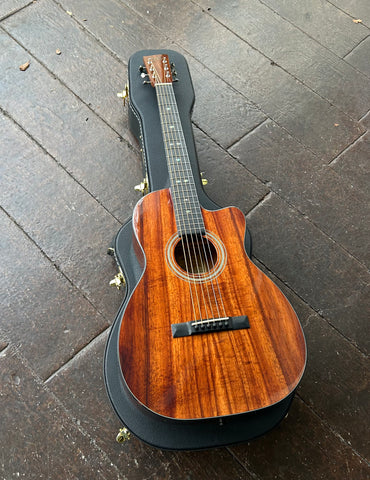 Top view Koa wood guitar with ebony bridge, ebony fretboard with diamond inlays, koa headstock