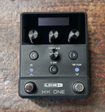Line 6&nbsp;HX One Guitar Multi-effects Floor Processor black with four control knobs on wood surface