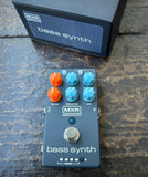 Dark grey MXR bass synth pedalwith six knob controls on a textured surface