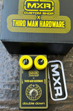 Black and yellow MXR custom shop guitar effects pedal with Third Man Hardware collaboration on a wooden surface.