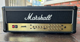 Black Marshall JVM guitar amplifier head with gold control plate on a wooden surface 