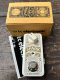Mini guitar TC Electronic Spark pedal with packaging on a wooden surface